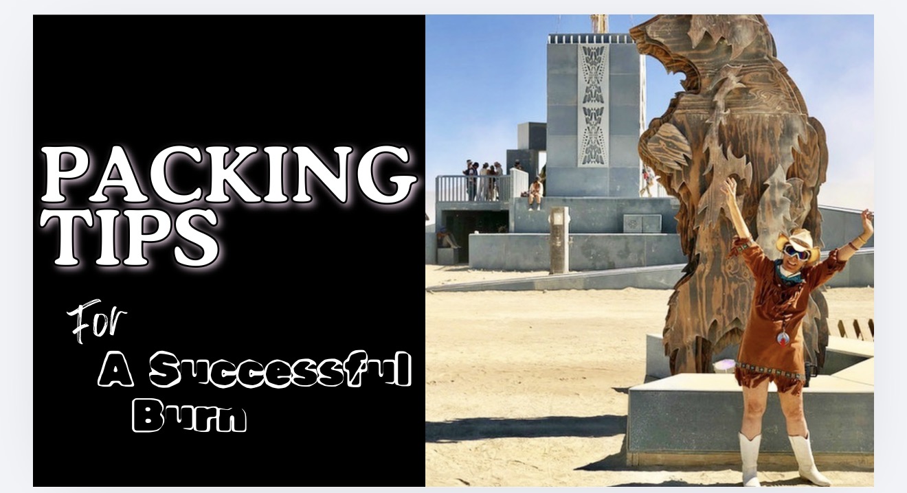 Zoe celebrating in front of a towering wooden Burning Man statue